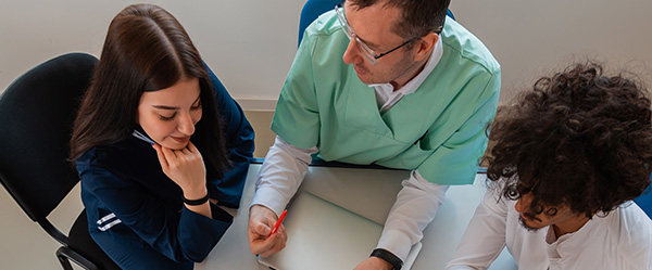 Doctors and patients sitting at a table.