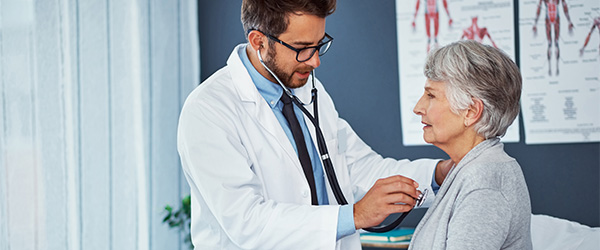 Doctor examining an older woman.