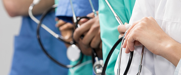 A group of doctors holding stethoscopes.