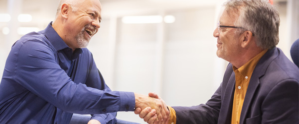 Two men shaking hands.